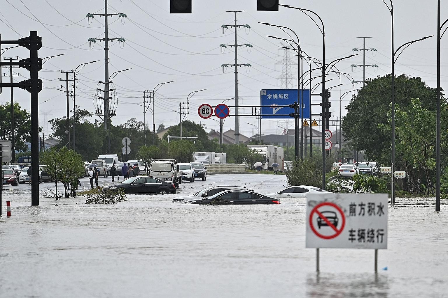 Cars stranded in a flooded area of Yuyao, near Ningbo city in eastern China's Zhejiang province, yesterday, after heavy rain from the passage of Typhoon In-Fa inundated parts of the city. Zhejiang, which is already at the highest Level 1 emergency re