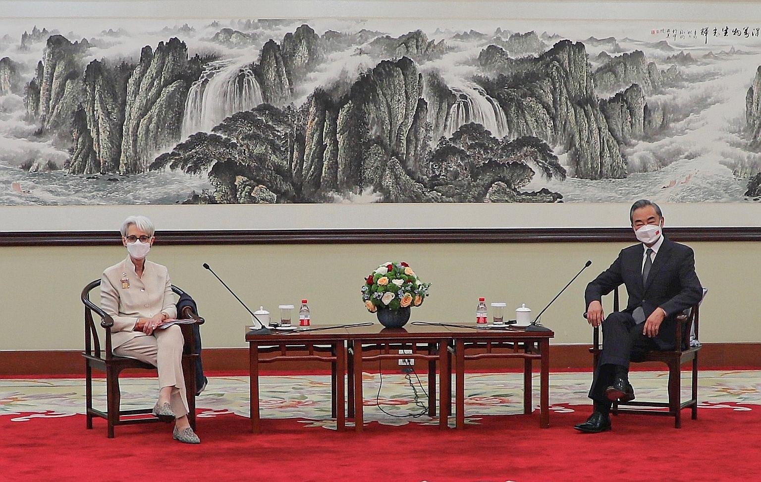 Chinese Foreign Minister Wang Yi meeting visiting US Deputy Secretary of State Wendy Sherman in Tianjin yesterday. He said that the Biden administration had continued its predecessor's "extreme and erroneous" policy against Beijing and that attempts 