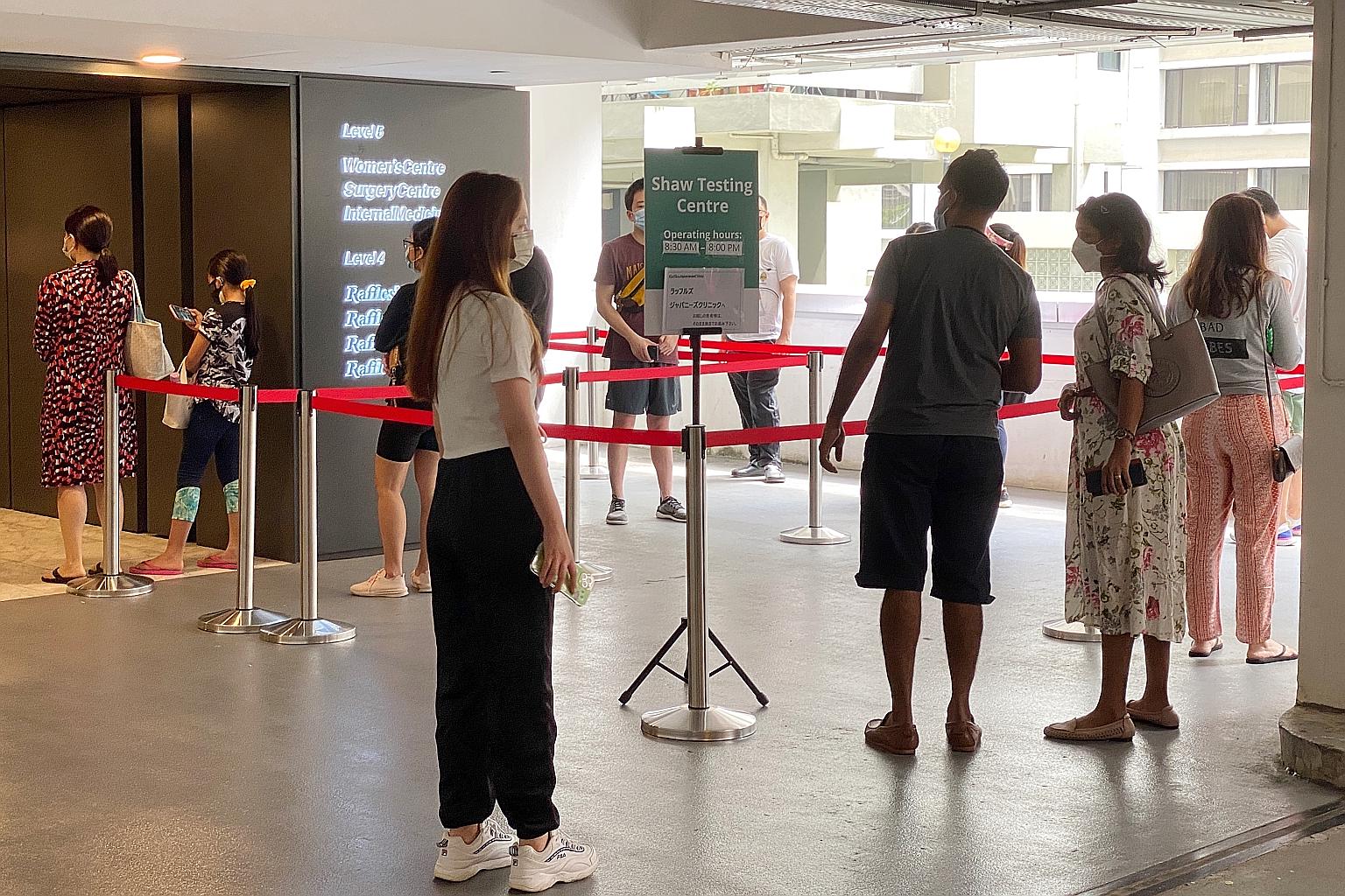 People waiting to enter the Raffles Medical test centre at Shaw Centre last month. The firm expanded its operations beyond air border screening and pre-event testing to include vaccination centres, pre-departure swabbing of cruise passengers, and PCR