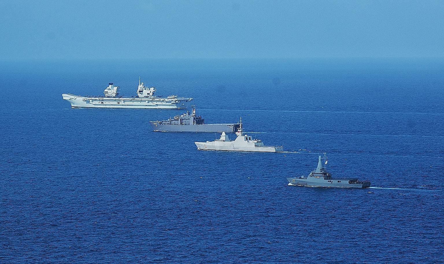 (From left) British aircraft carrier HMS Queen Elizabeth, landing ship tank RSS Resolution, frigate RSS Intrepid and littoral mission vessel RSS Unity during an exercise between the British carrier strike group and the Singapore navy on July 26. PHOT