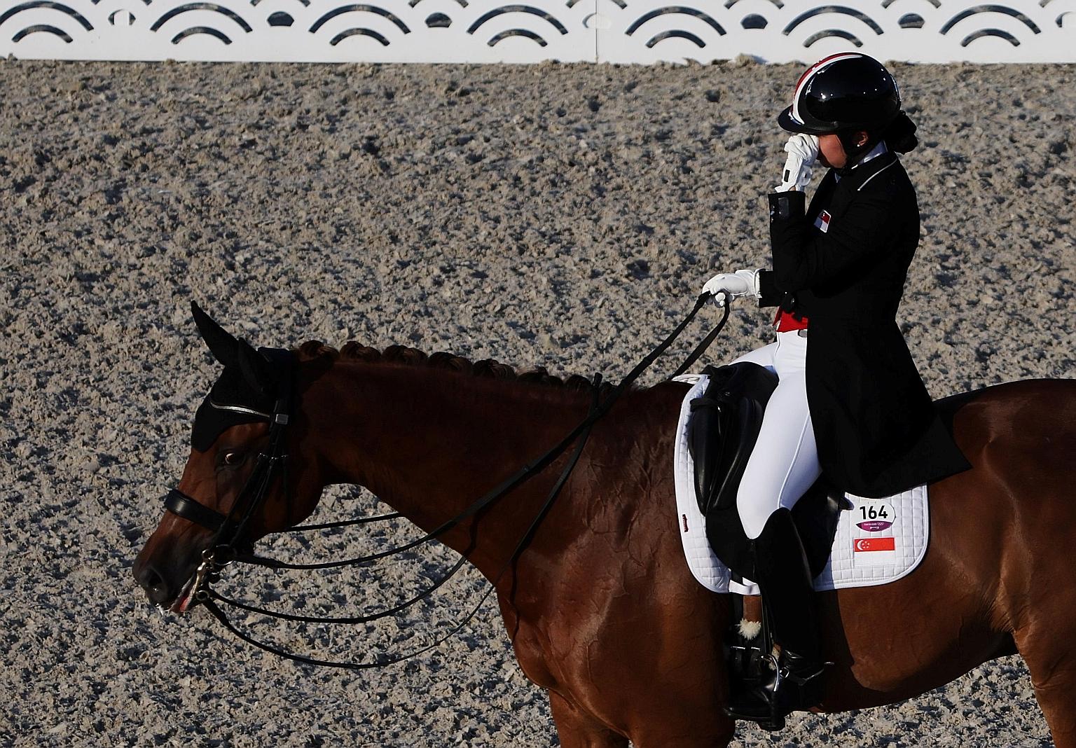 Caroline Chew on her horse Tribiani during the Olympic dressage on Sunday. She was eliminated after Tribiani was discovered to be bleeding from its lower lip.