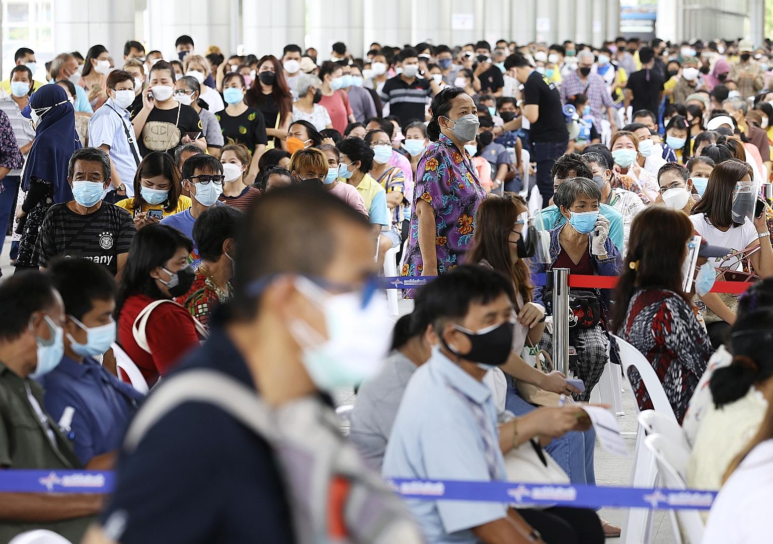 People waiting for their jabs at the crowded Bang Sue Vaccination Centre in Bangkok yesterday. Thailand reported a daily record of 16,533 new infections yesterday. PHOTO: EPA-EFE