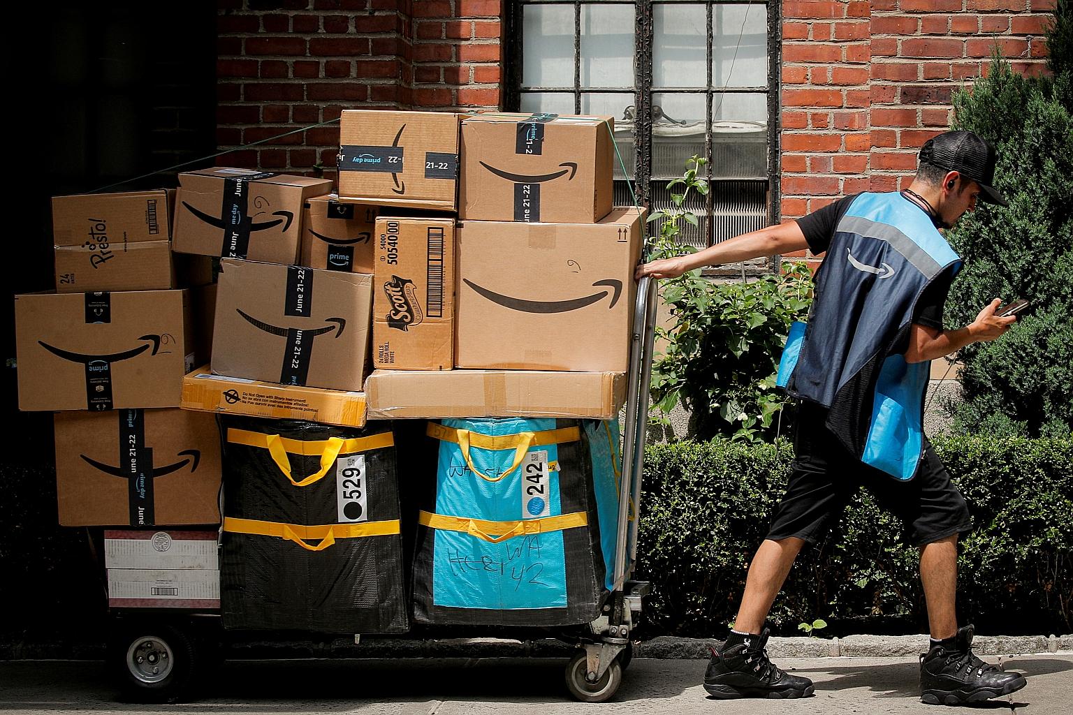 An Amazon delivery worker in New York last month. The company has invested billions to operate through the pandemic, while minimising the spread of Covid-19 through its facilities and hiring hundreds of thousands of workers to meet crushing demand.