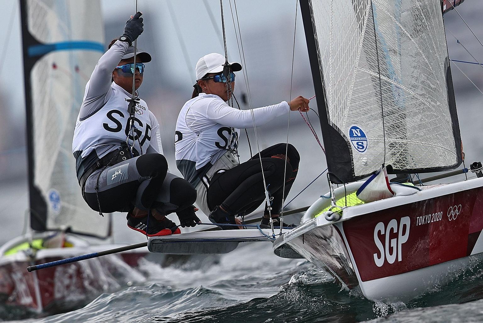 Cecilia Low (left) and Kimberly Lim racing in the women's 49er FX off Enoshima Yacht Harbour on Friday. They made the medal race by being ninth overall.