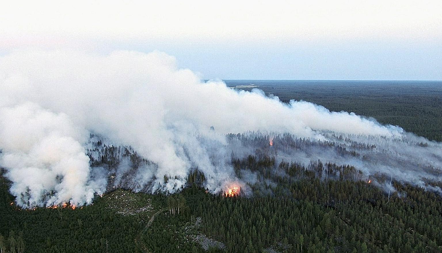 The forest fire raging in Kalajoki, north-western Finland, on Monday. An exceptionally long heatwave saw the country experiencing record temperatures this summer, with June averaging 20 deg C, some four to five degrees above historical averages. PHOT