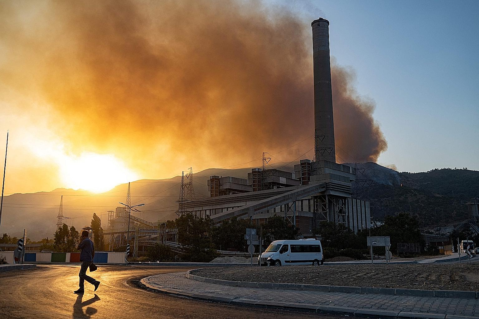 A man in the vicinity of a forest fire close to the Kemerkoy thermal power plant in Milas, Turkey, on Wednesday. In the past two weeks, fires in Turkey have razed more than three times the area affected in an average year, said a European fire agency
