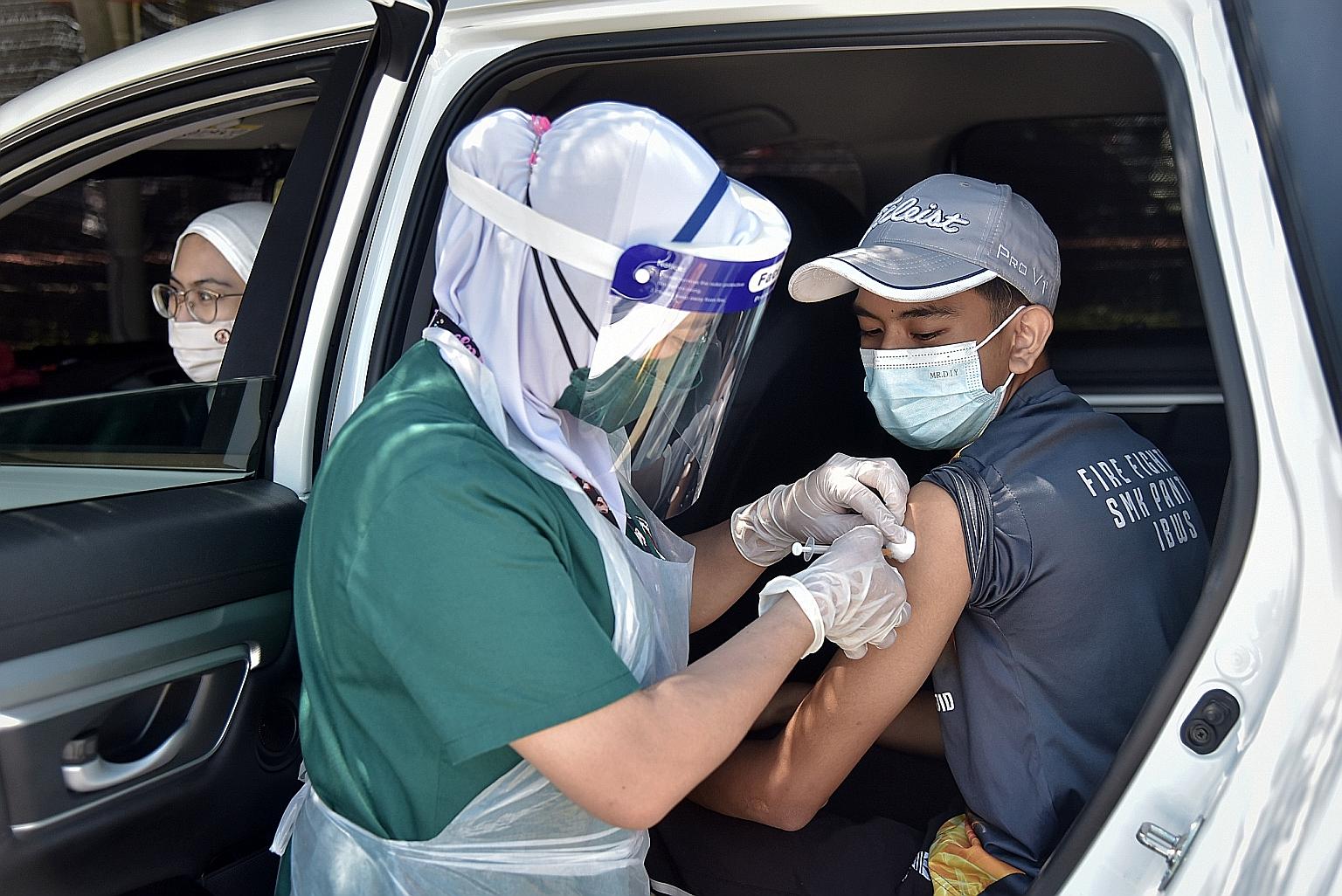 A Covid-19 vaccine being administered at the vaccination centre at Universiti Malaysia Sabah. Over eight million people, or about 36 per cent of the adult population, have been fully inoculated, with the Malaysian government projecting 50 per cent co