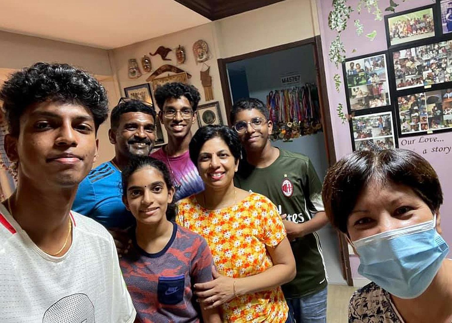 Minister in the Prime Minister's Office Indranee Rajah (right), who is also an MP for Tanjong Pagar GRC, with national athlete Thiruben Thana Rajan (left) and his family.