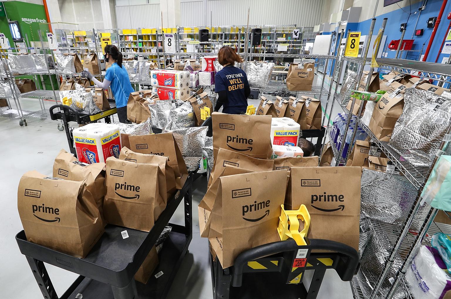 Workers at the Amazon Fresh Fulfilment Centre. Groceries from Amazon Fresh, digital goods and services such as in-app purchases on Amazon service Twitch, as well as subscription schemes such as Amazon Prime will not be affected by the surcharge. When