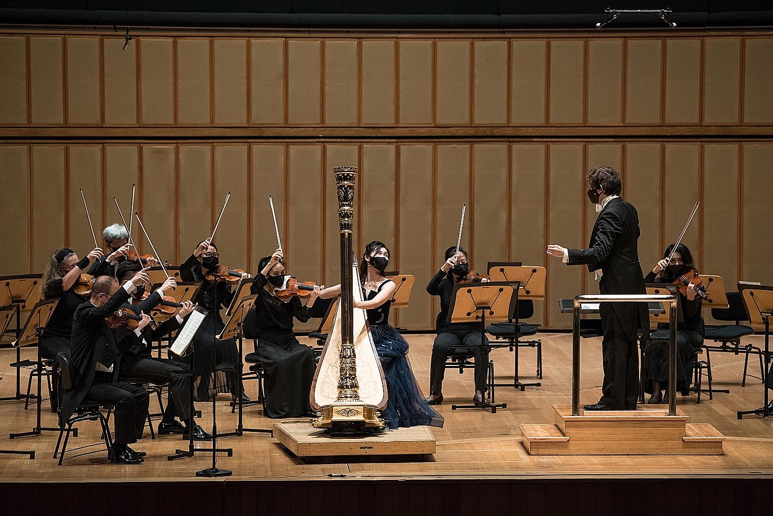 Harpist Charmaine Teo (centre, foreground) with the Singapore Symphony Orchestra at the President's Young Performers Concert.