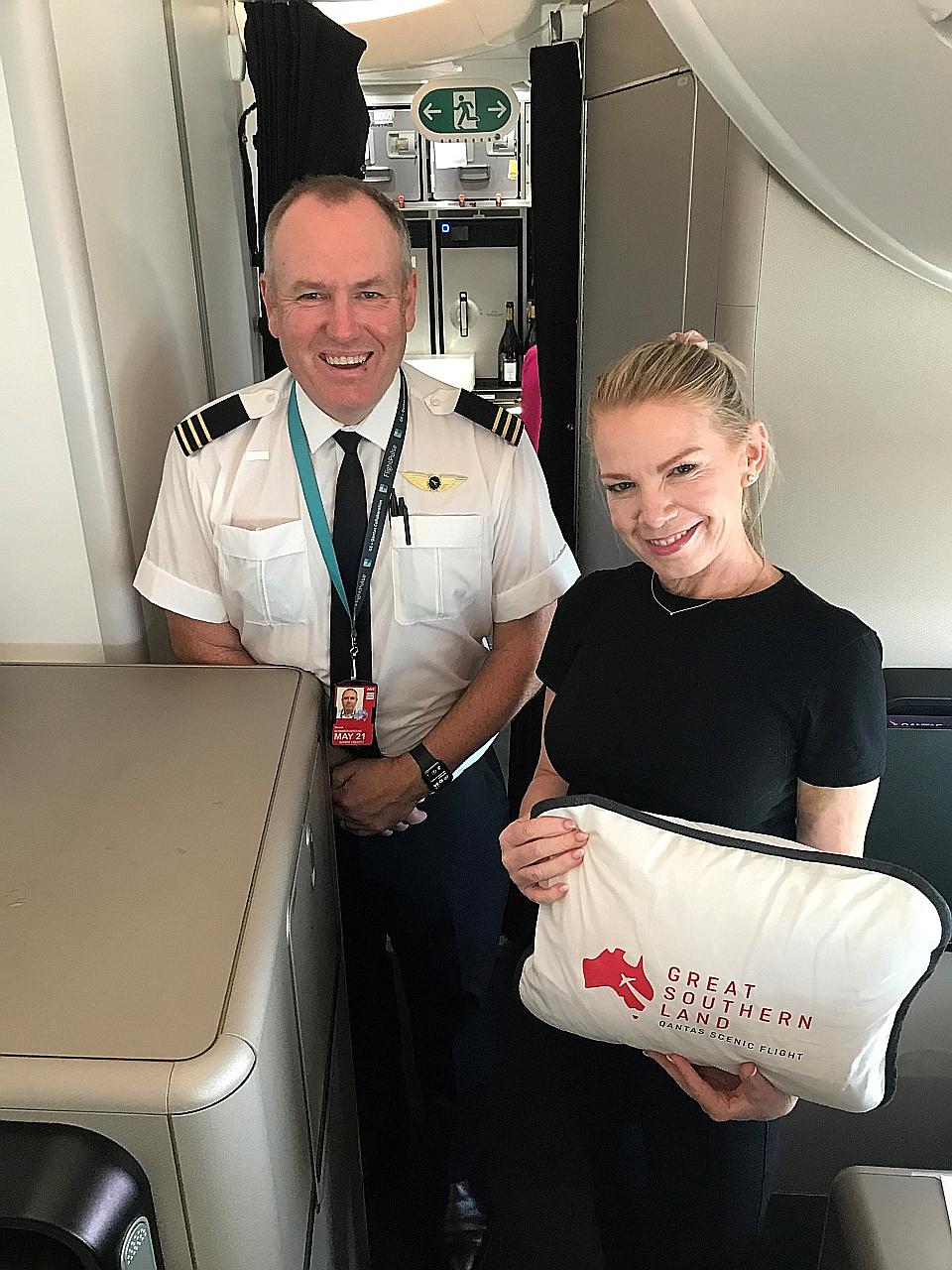 Qantas Platinum One flier Fiona Downes, posing with pilot David Summergreene on board the Qantas 787 Dreamliner on the eight-hour "Flight to Nowhere" around Australia on Oct 10 last year, hopes to retain her elite status.
