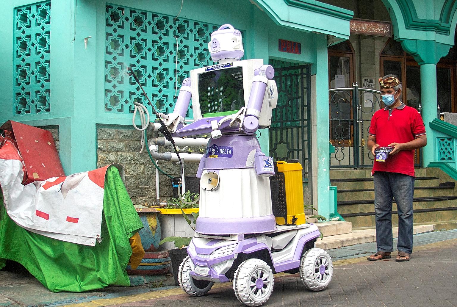 The "Delta robot" being operated by Mr Aseyanto, a neighbourhood leader who heads the project in the village of Tembok Gede in Surabaya, Indonesia's East Java province. The robot was put together using household items.