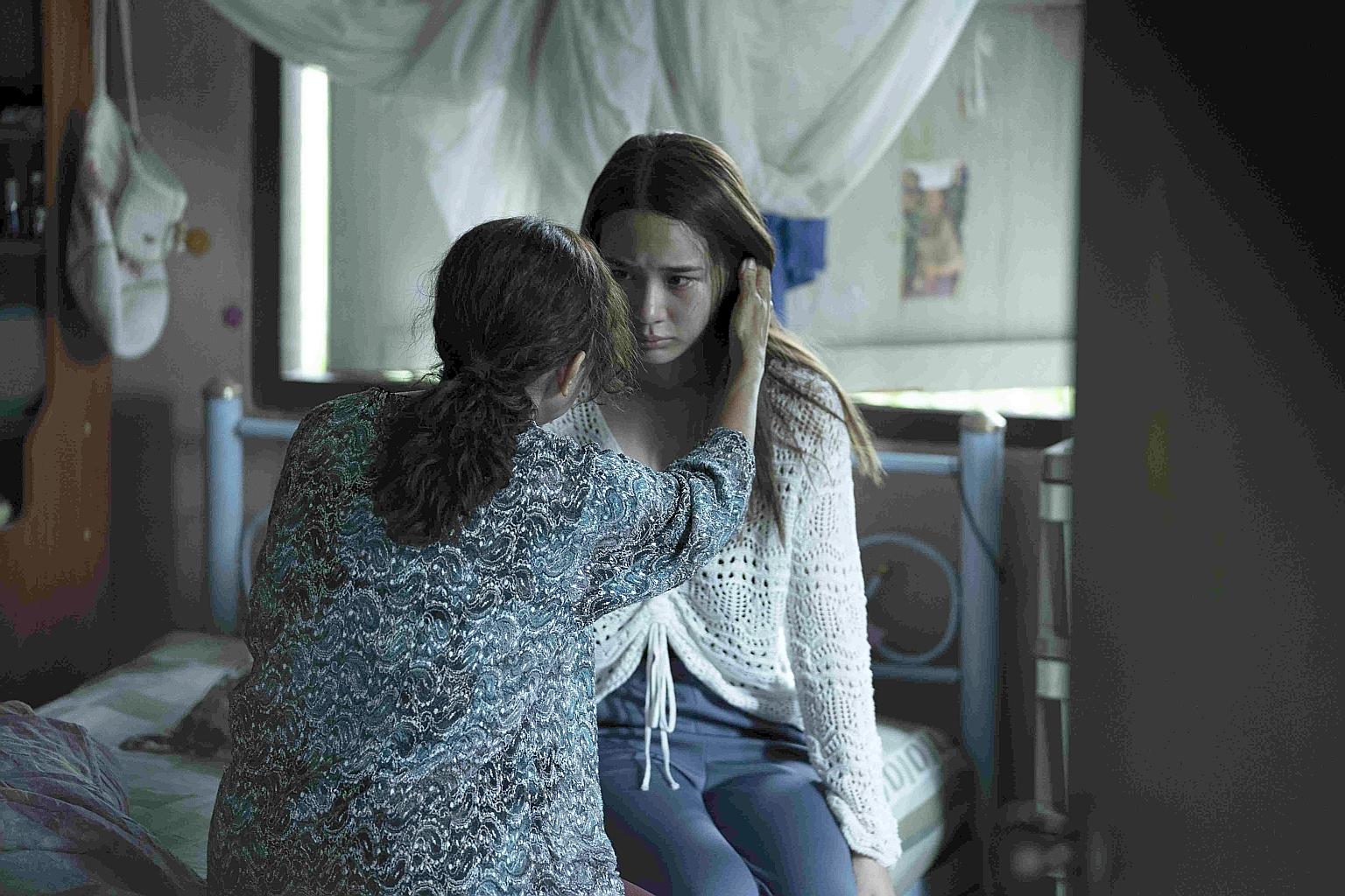 The Medium stars Narilya Gulmongkolpech (in white).