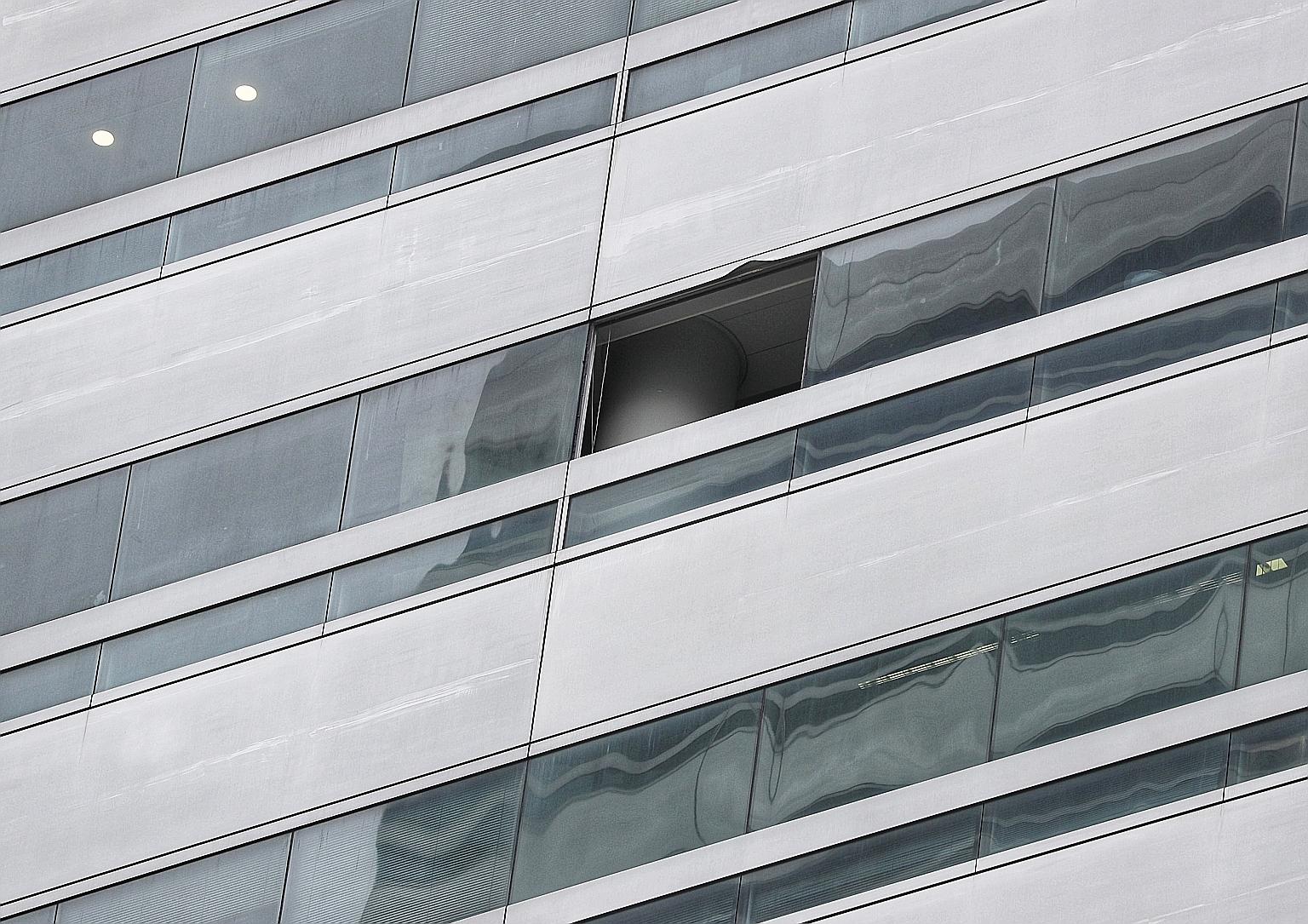 A gas canister had burst in a vacant unit at The Gateway West on Tuesday, smashed through the window and ricocheted off the ground before crashing into the glass panels on The Gateway East opposite. ST PHOTO: KELVIN CHNG