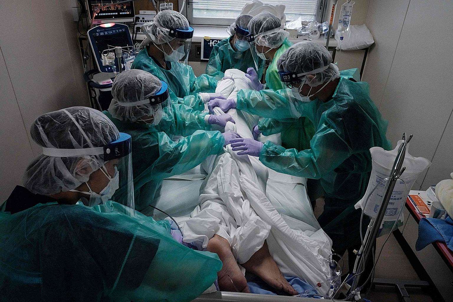 Medical workers attending to a Covid-19 patient in the intensive care unit at St Marianna University School of Medicine, Yokohama City Seibu Hospital, in Yokohama, on Sunday. There has been public unease over the policy announced by Prime Minister Yo