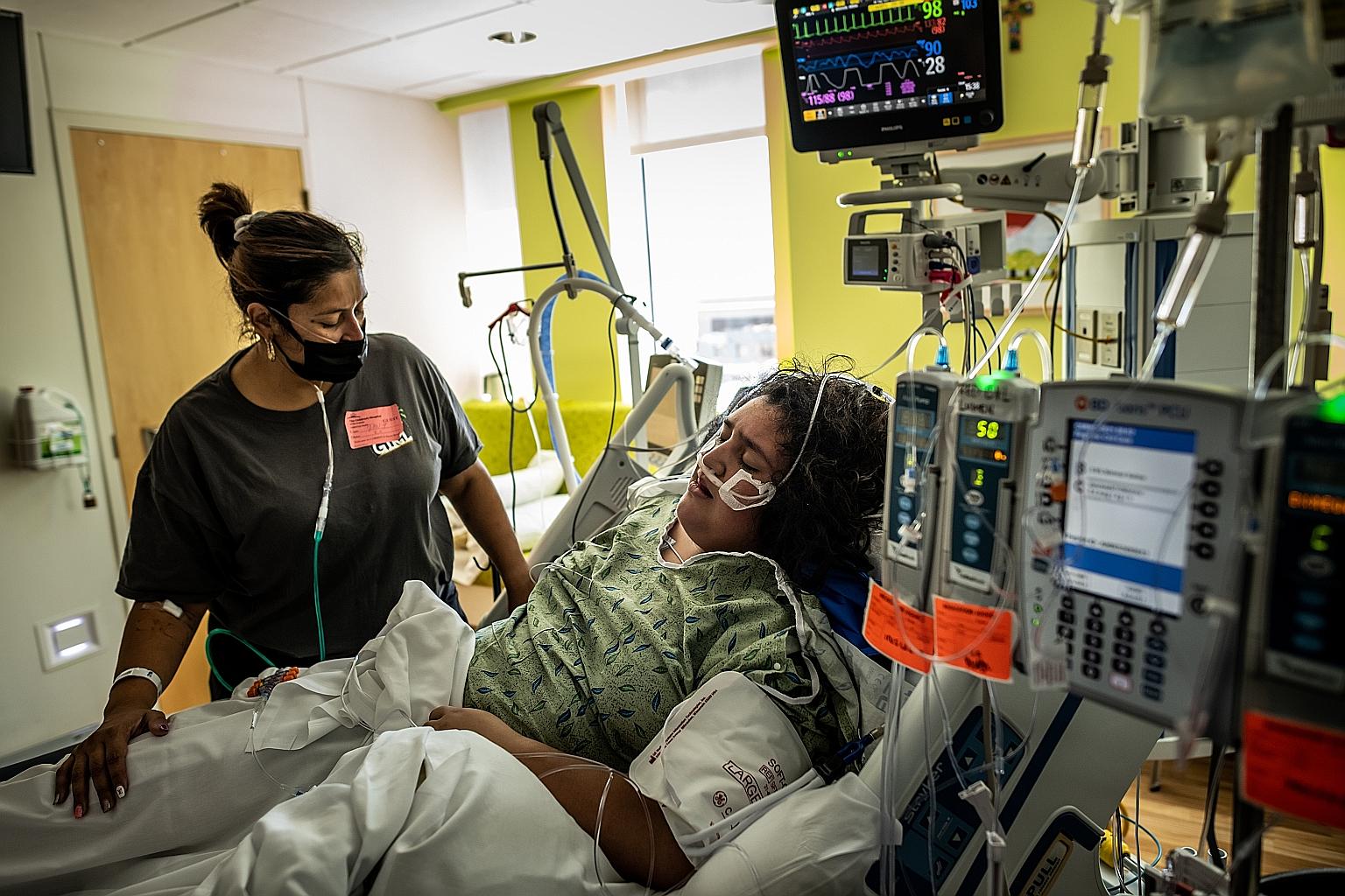 A woman comforting her 14-year-old daughter who has been put on a ventilator in the Children's Hospital of San Antonio in Texas on Tuesday. The three drugs to be tested by the WHO were chosen by an expert panel for their potential in reducing the ris