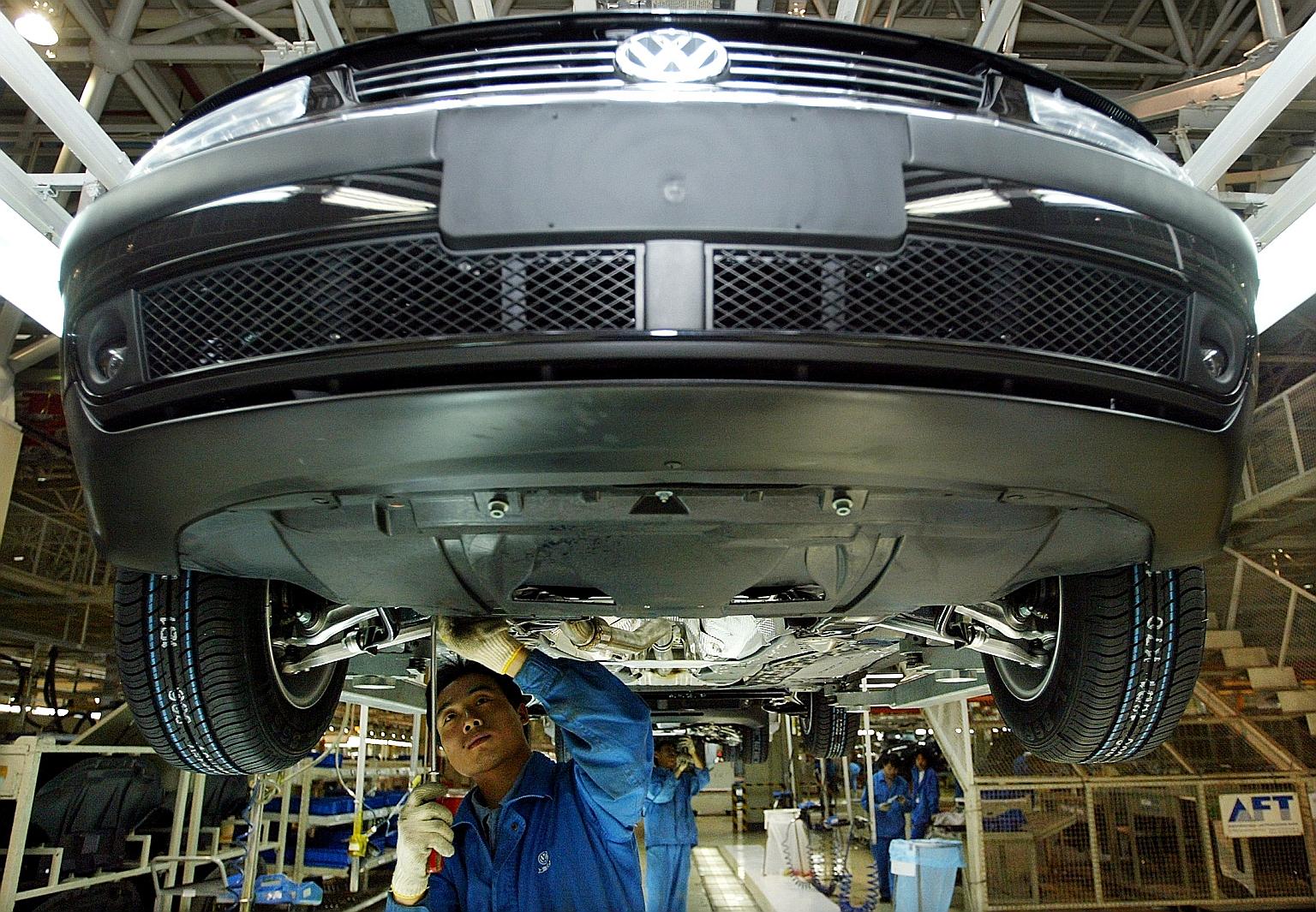 A 2003 file photo of a Chinese worker assembling a Volkswagen Passat at a Shanghai plant. Sales of the Passat have slumped in China, something Volkswagen has attributed mainly to the backlash over an unofficial safety test carried out in 2019 by an i
