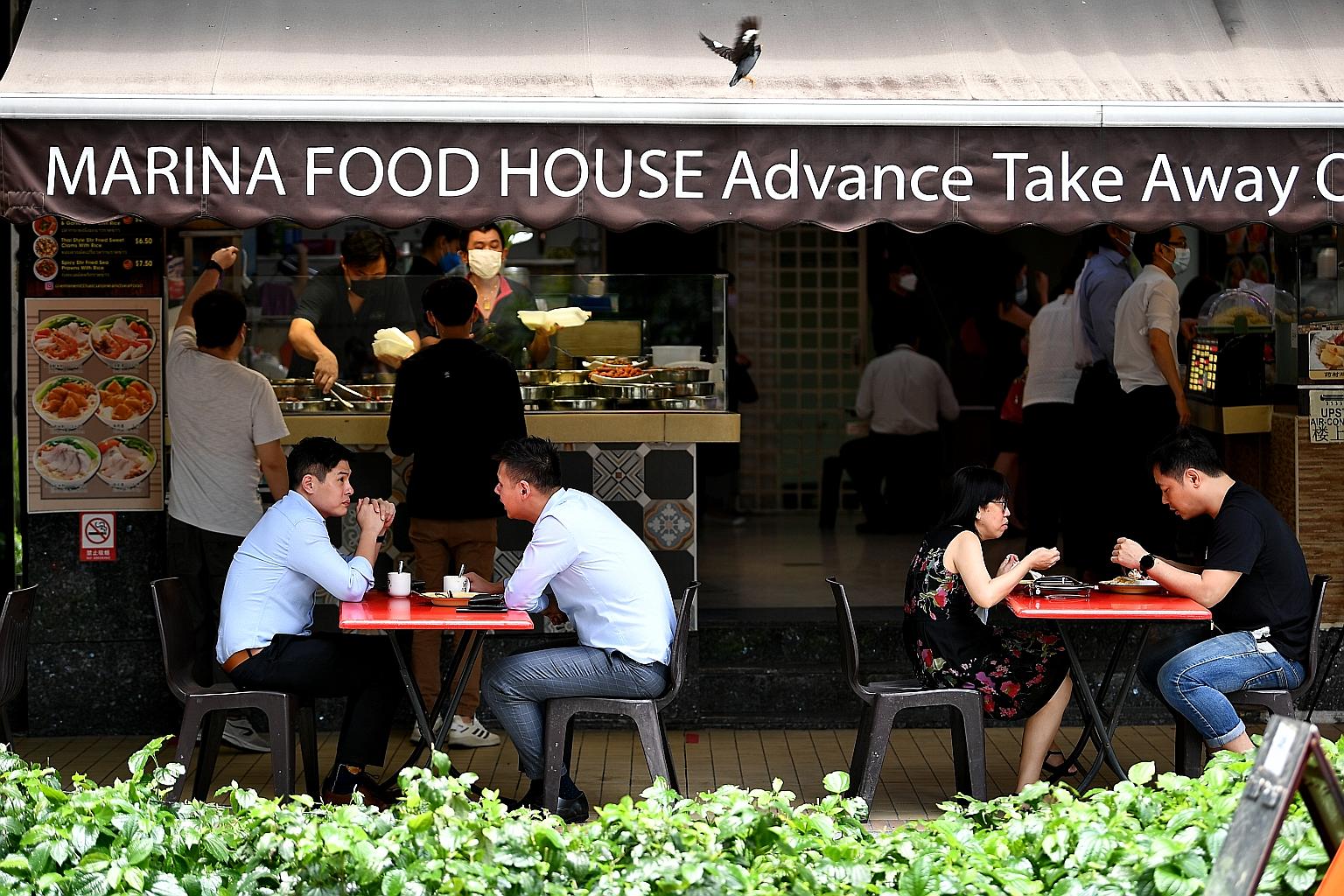 People dining in at Marina Food House in Phillip Street on Thursday. Following the latest set of rules which kicked in on Tuesday, only hawker centres and coffee shops are able to accept groups of two diners regardless of vaccination status.