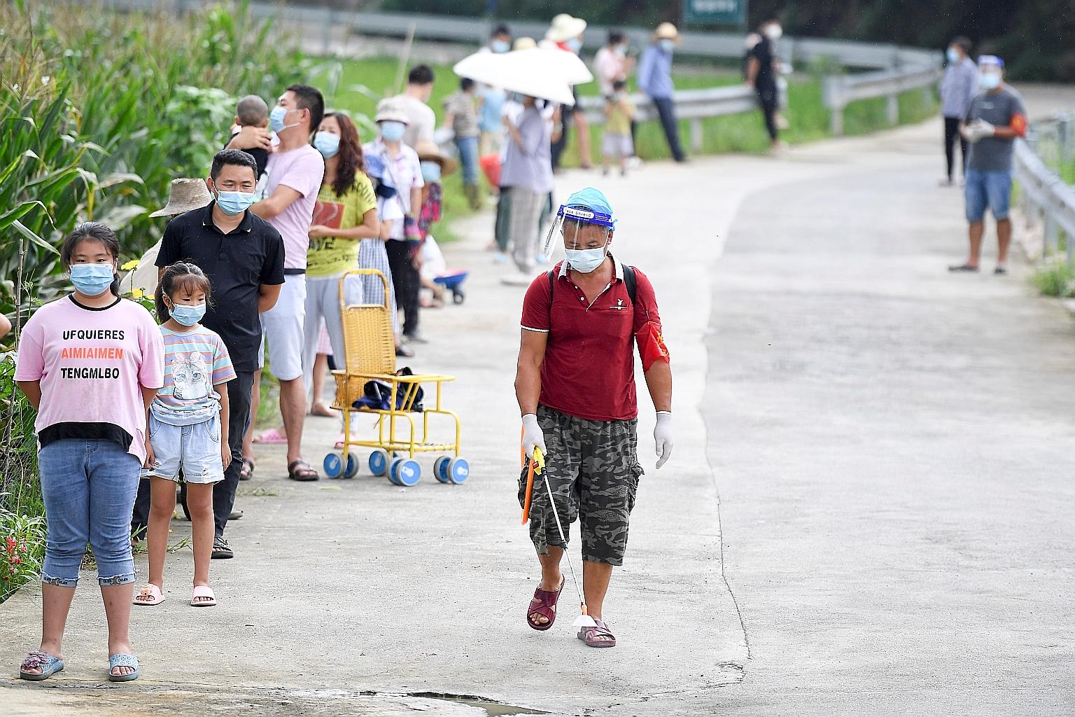 In an updated guideline issued by China's National Health Commission on Friday, members of the public are required to wear surgical masks in venues such as cinemas, malls, theatres, parks, open squares and on public transport. PHOTO: REUTERS