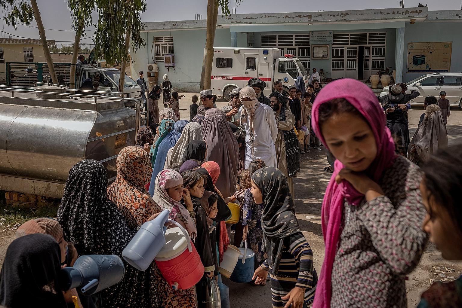 People lining up for water earlier this month at a camp in Kandahar for families who have fled the fighting between Afghan government forces and Taleban militants. PHOTO: NYTIMES