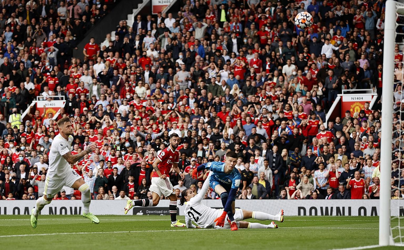Manchester United's Bruno Fernandes (in red) scoring their first goal in the 5-1 win over Leeds yesterday. Apart from Fernandes' treble, Paul Pogba also starred with his four assists.