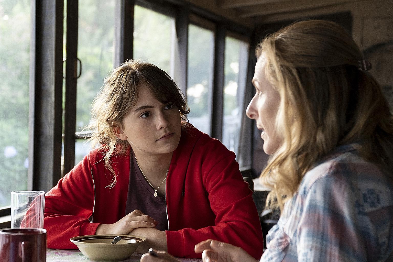 Emilia Jones as a hearing child of deaf adults who aspires to be a singer and deaf performer Marlee Matlin (both left) as her mum in the film Coda.