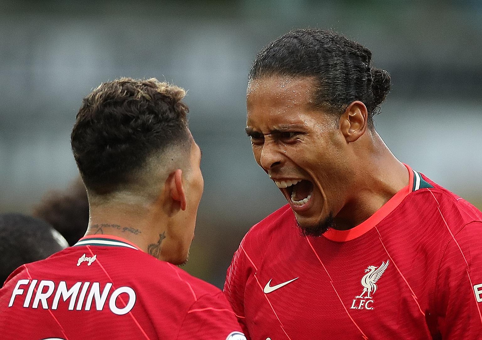 Roberto Firmino celebrates scoring Liverpool's second goal with Virgil van Dijk, who played his first game since a bad knee injury last October.