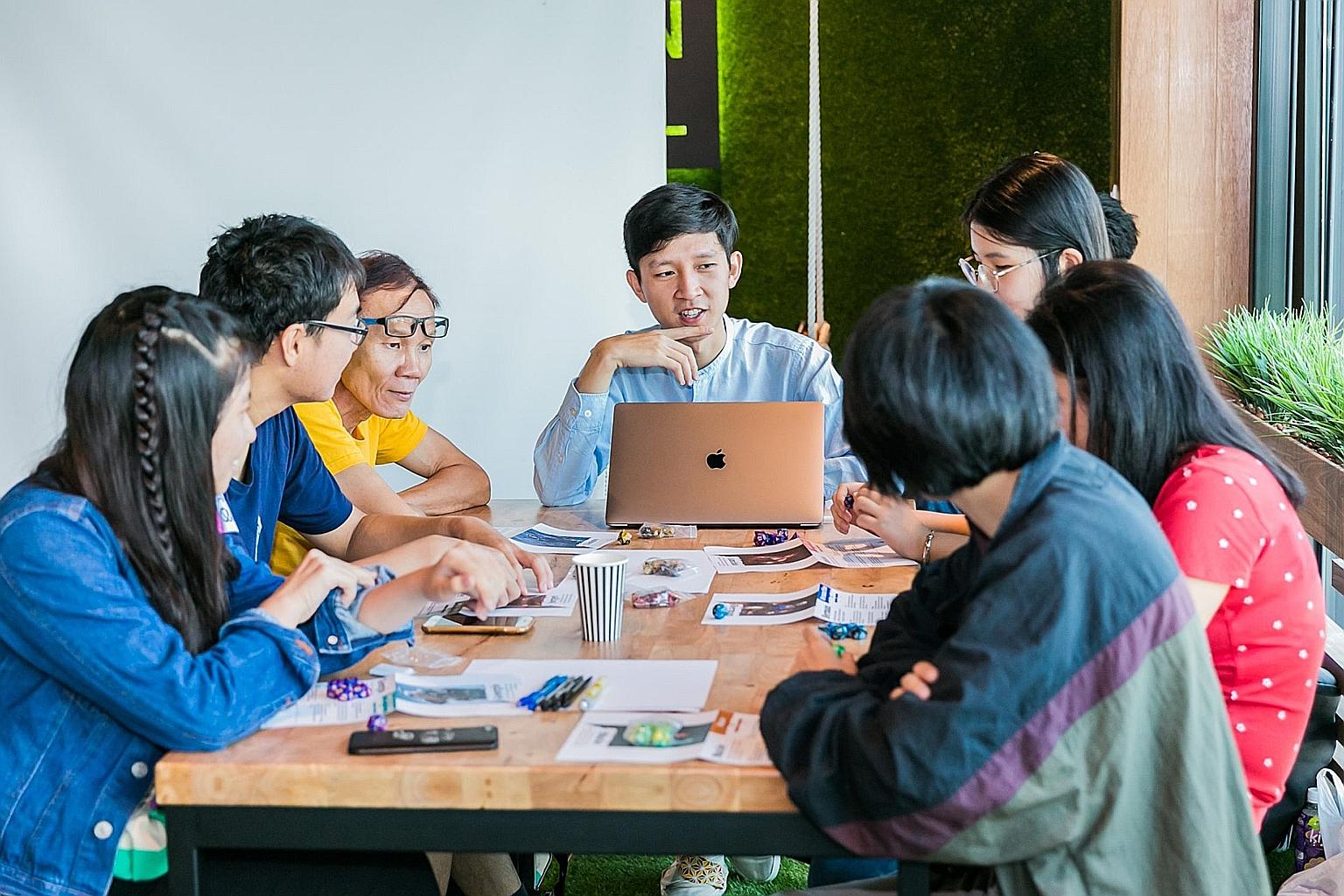 Mr Louis Puah (centre) facilitating a role-playing game on issues related to at-risk youth in Singapore in 2019. The activity was conducted by A Good Space, which was officially set up as a co-op in March last year and brings together people who want