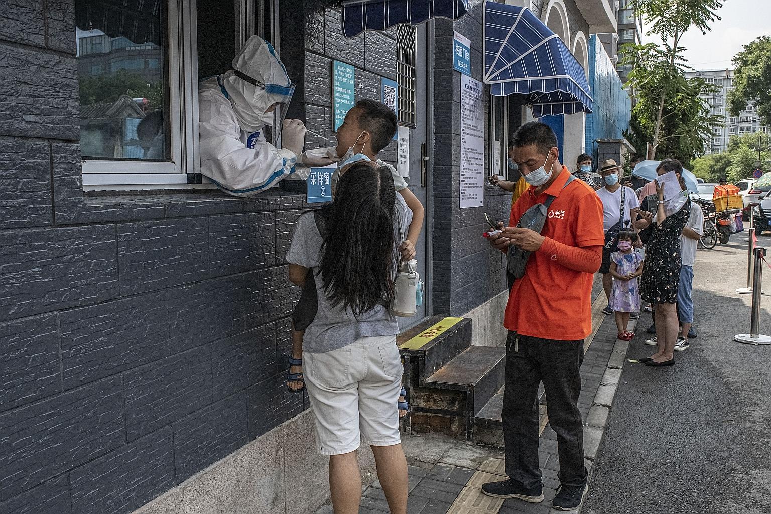 A child in Beijing getting a Covid-19 swab test earlier this month. The Delta variant of the coronavirus has breached China's defences, with record local cases in dozens of cites - albeit still in low numbers - leading the authorities to reintroduce