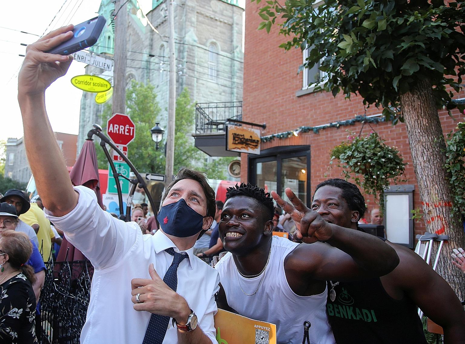 Canada's Prime Minister Justin Trudeau taking a selfie with supporters during a campaign stop in Montreal, Quebec, on Sunday.