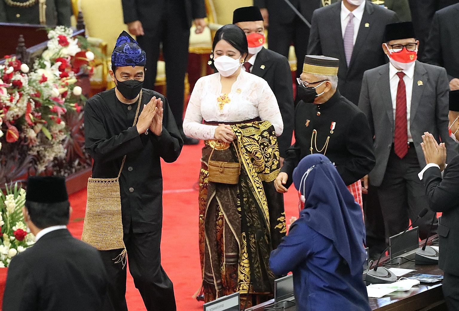 Indonesian President Joko Widodo, dressed in tribal wear, greeting MPs yesterday ahead of his annual address to Parliament in Jakarta. With him were the House Speaker, Ms Puan Maharani, and Vice-President Ma'ruf Amin (second from right).