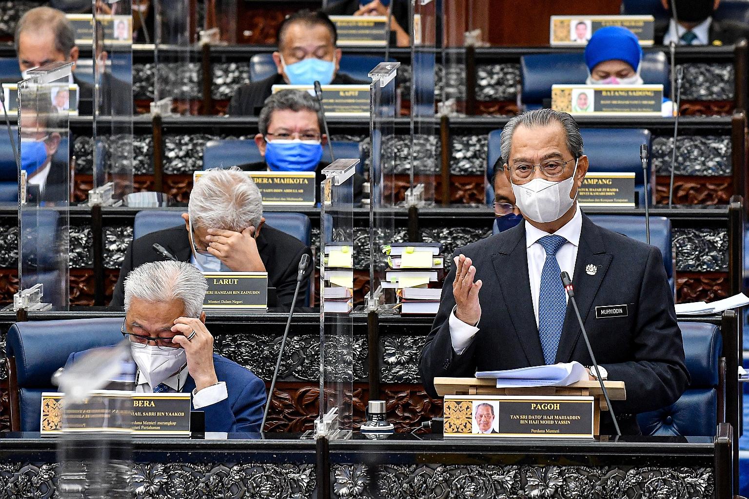 Tan Sri Muhyiddin Yassin, who resigned as Malaysia's prime minister on Monday, at a Parliament session on July 26. When asked during a news conference on Monday if he may yet be reappointed, Mr Muhyiddin replied: "Well, let's see." PHOTO: REUTERS