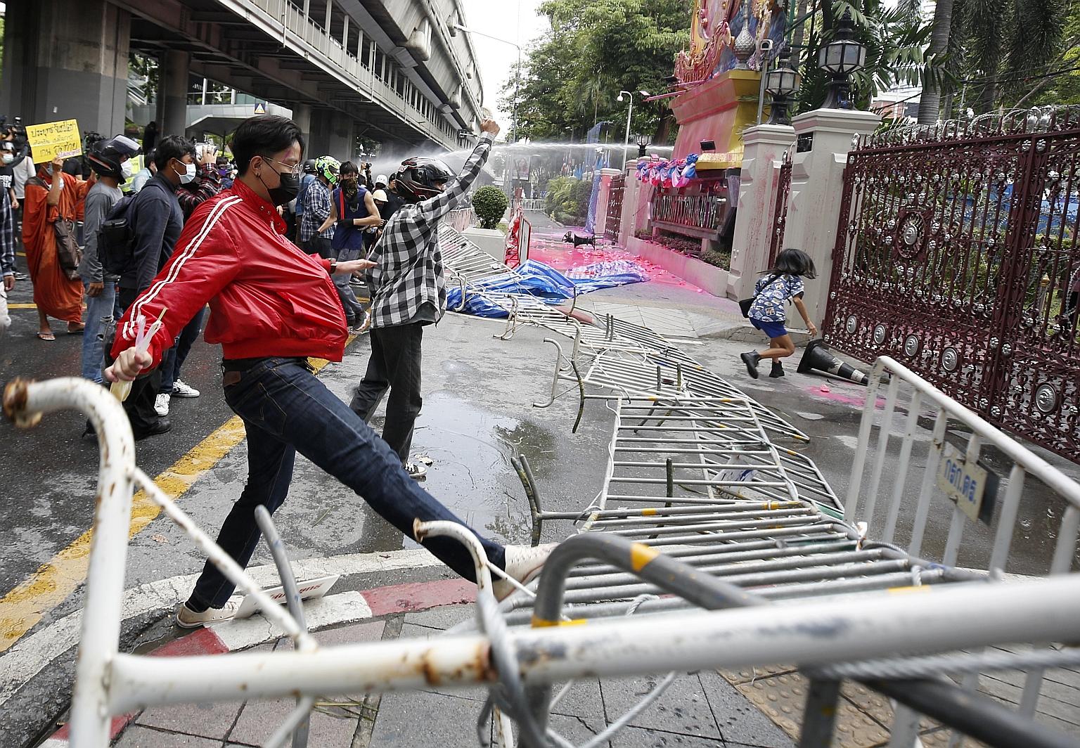 Anti-government protesters facing off against police during a demonstration outside the Royal Thai Police headquarters in Bangkok yesterday.