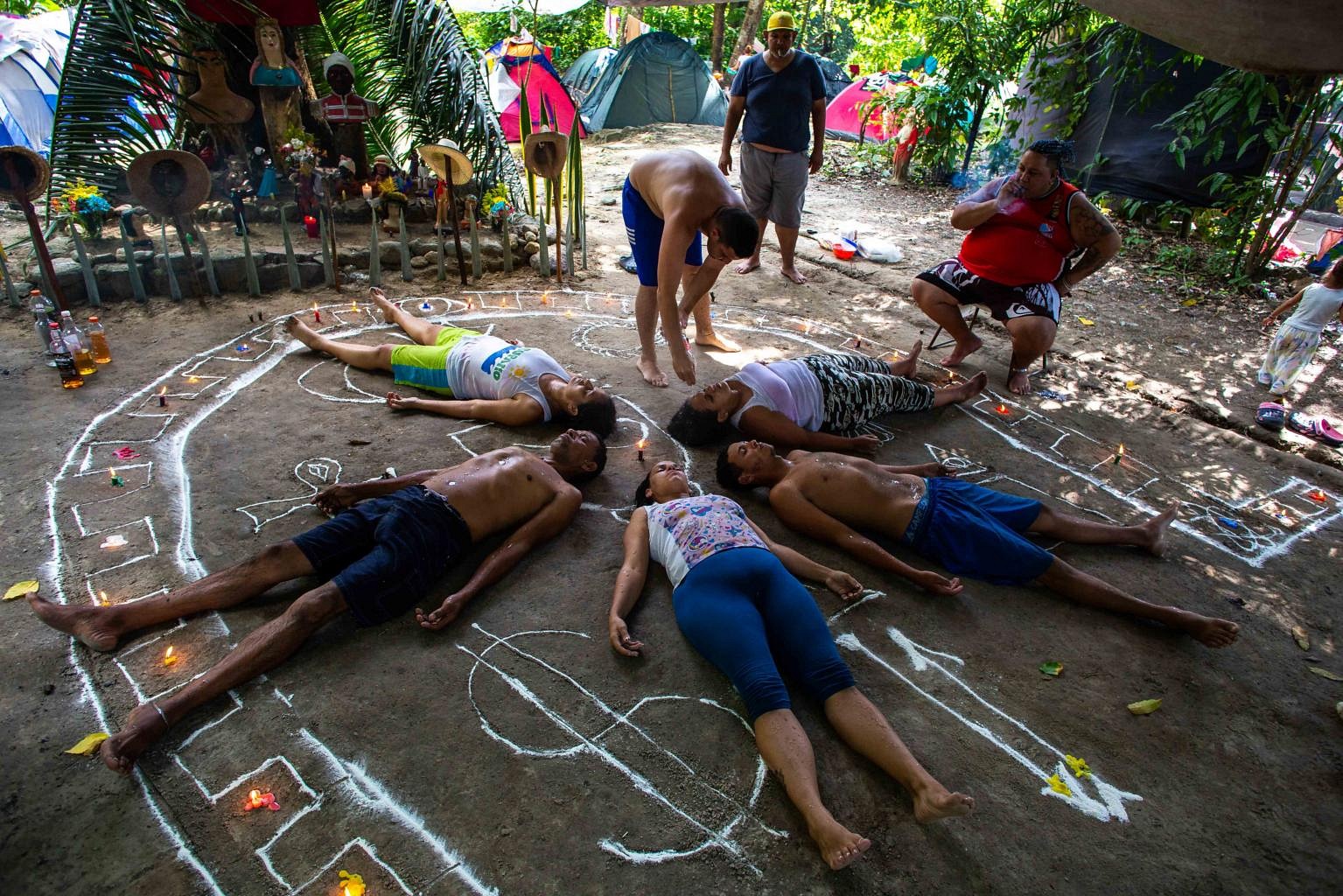 Fire, tobacco and spirits: Venezuelans fight Covid-19 with ritual | The ...