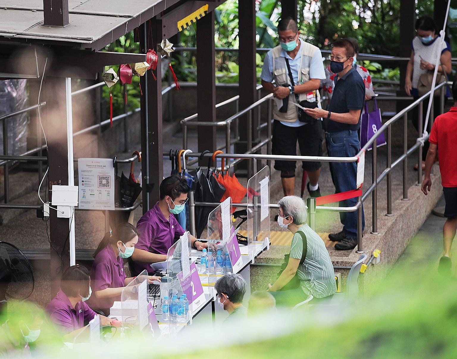 Seniors registering for their booster shots at Bishan Vaccination Centre on Oct 1. ST PHOTO: GIN TAY