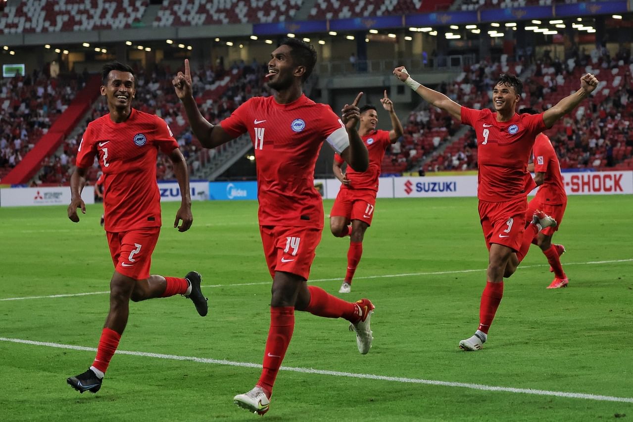 <p>Singapore skipper Hariss Harun (No. 14) celebrating after scoring the opening goal against the Philippines in the Asean Football Federation Suzuki Cup at the National Stadium on Dec 8, 2021.</p>
