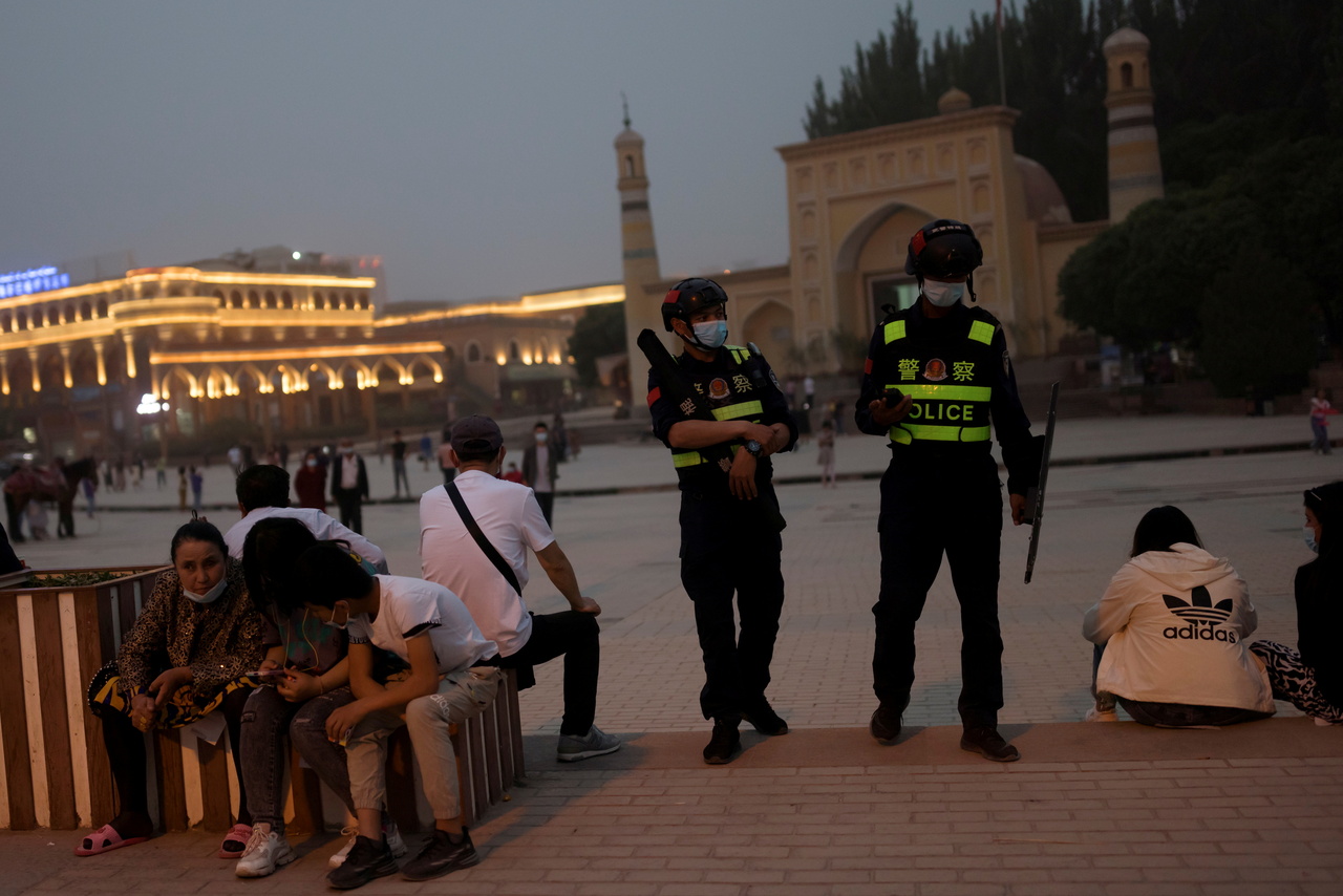 <p>FILE PHOTO: Police officers patrol the square in front of Id Kah Mosque in Kashgar, Xinjiang Uyghur Autonomous Region, China, May 3, 2021. Picture taken May 3, 2021.  REUTERS/Thomas Peter/File Photo</p>