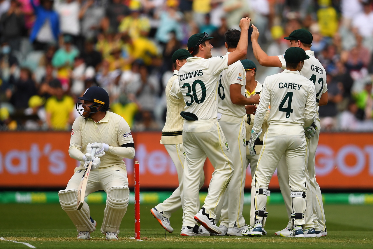 Australian players celebrate after dismissing English Jonny Bairstow (left) during day 1 of the third Ashes Test against England on, Dec 26, 2021.