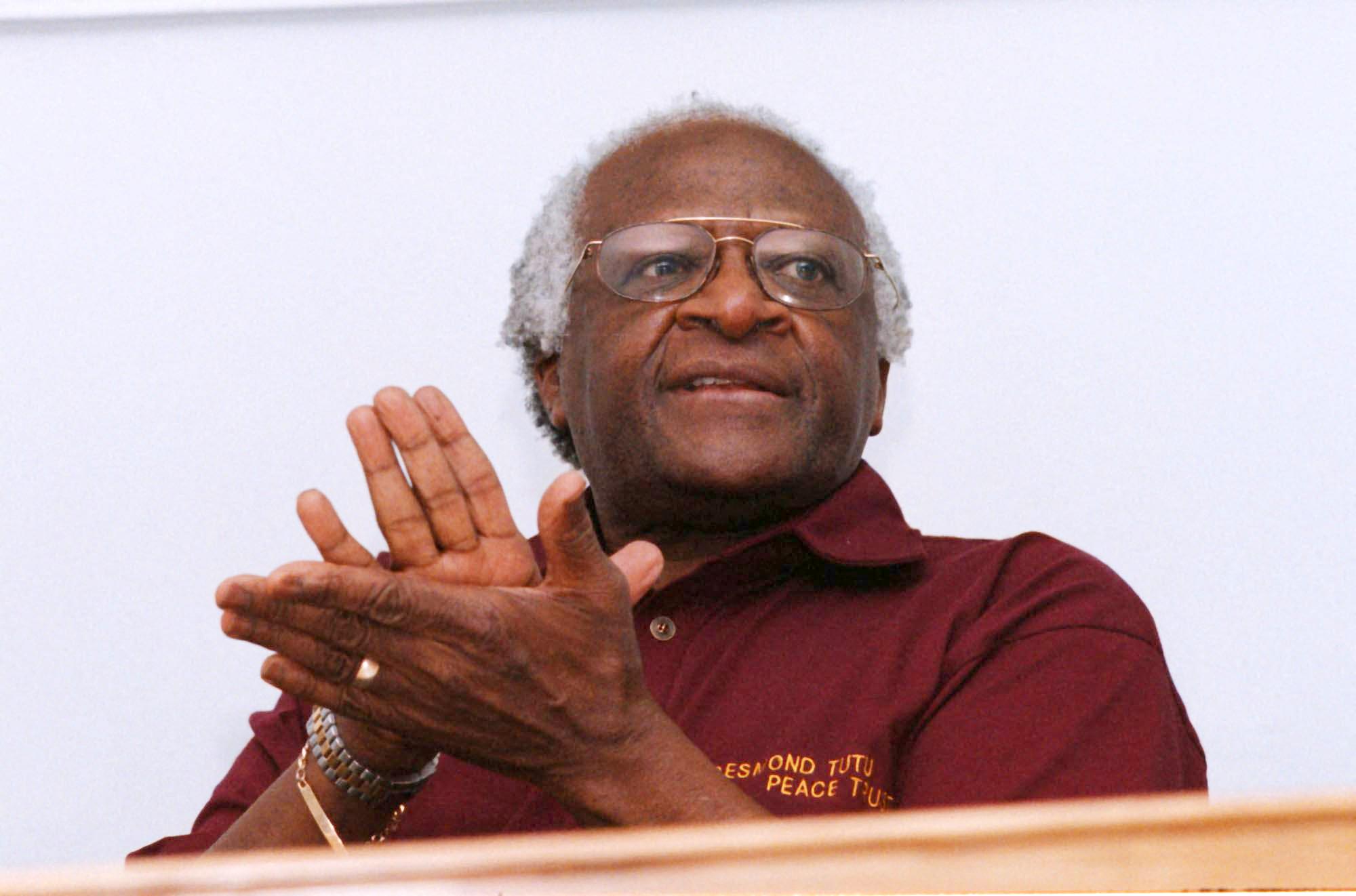 <p>(FILES) In this file photo taken on October 27, 1998 Truth and Reconciliation Commission (TRC) chairman Archbishop Desmond Tutu claps at the end of the press conference which concludes the activities of the TRC at the TRC offices in Cape Town. - South