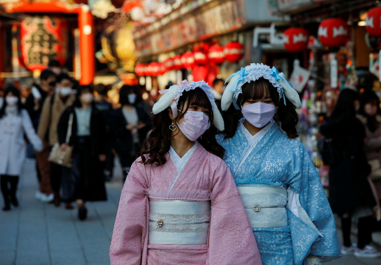 <p>Visitors wearing protective face masks walk under decorations for the New Year at Nakamise street leading to Senso-ji temple at Asakusa district, a popular sightseeing spot, amid the coronavirus disease (COVID-19) pandemic, in Tokyo, Japan, December 24
