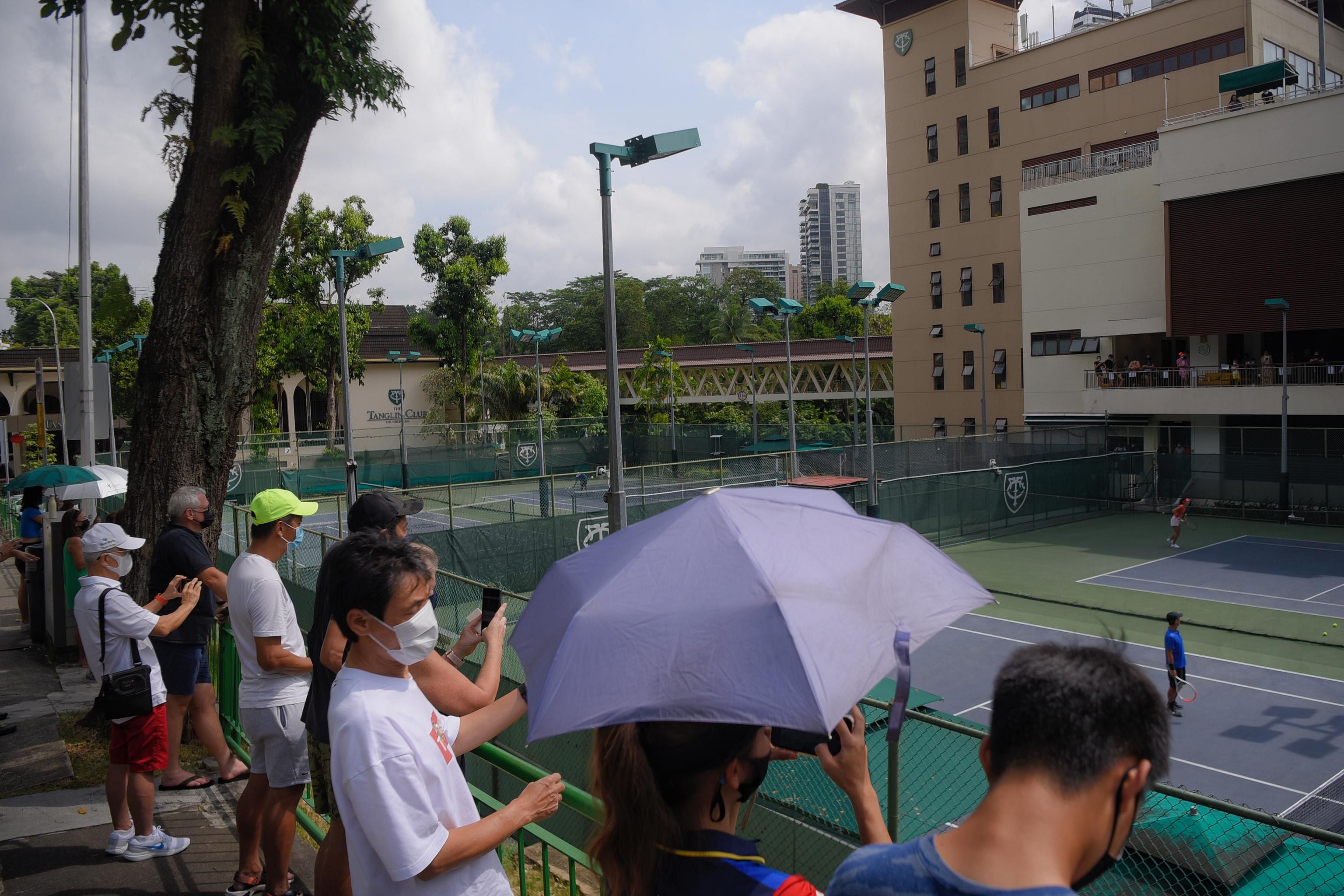 Fans gather to watch tennis star Emma Raducanu's practice session at the Tanglin Club on Jan 26, 2022.