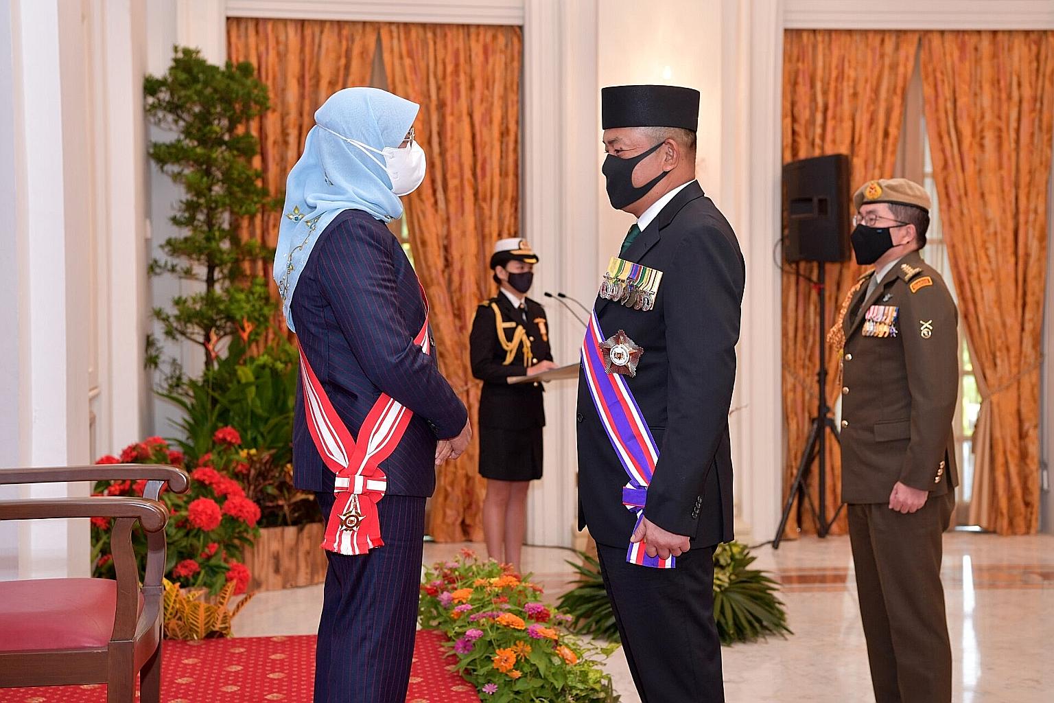 President Halimah Yacob with Major-General (Udara) Dato Seri Pahlawan Haji Hamzah Haji Sahat, former commander of the Royal Brunei Armed Forces, at the Istana yesterday. Maj-Gen (U) Dato Hamzah received the Darjah Utama Bakti Cemerlang (Tentera), or 