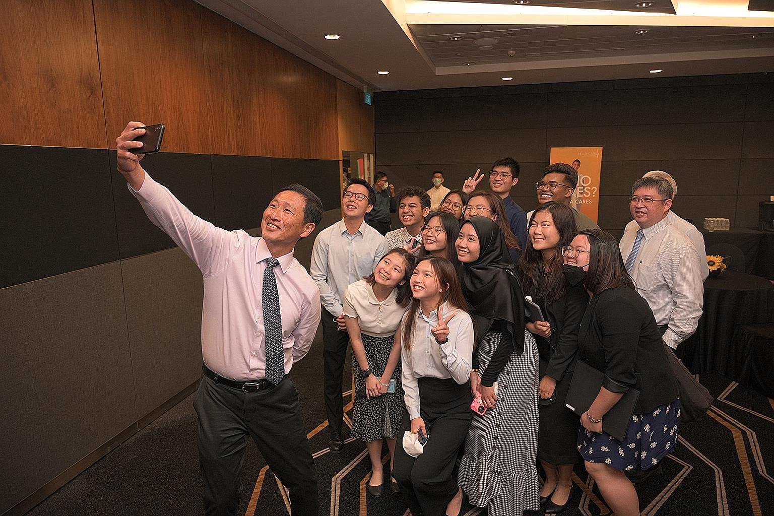 Health Minister Ong Ye Kung (left) taking a wefie after the 2022 Healthcare Scholarships Award Ceremony with some of the students who received scholarships, including Ms Zelda Chee (in short-sleeved white shirt), who will be pursuing a nursing degree