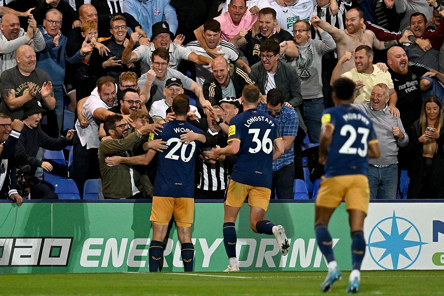 Newcastle striker Chris Wood celebrating with fans after scoring the winner in the 2-1 League Cup win over Tranmere Rovers.