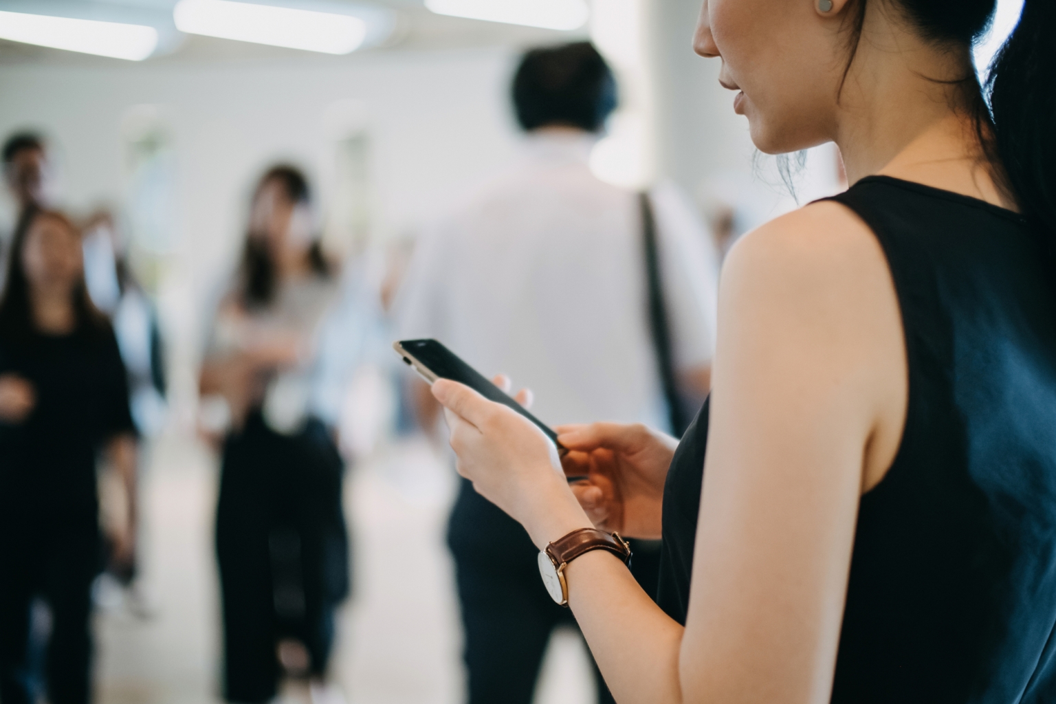 Woman uses smartphone for banking and financial needs