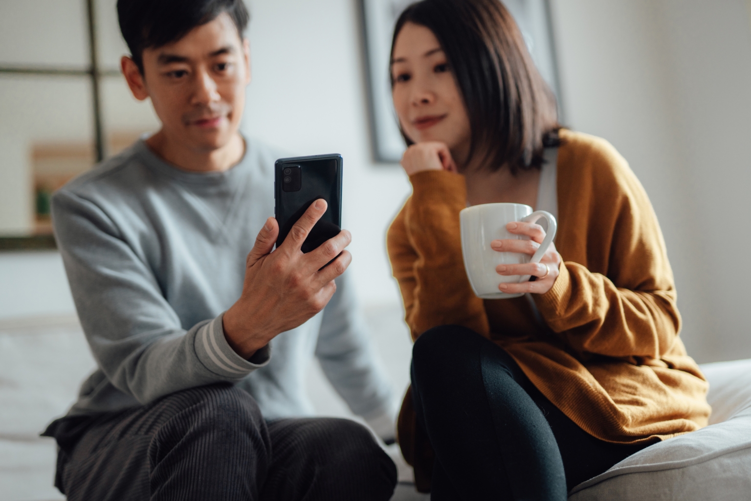 A man and woman investing digitally
