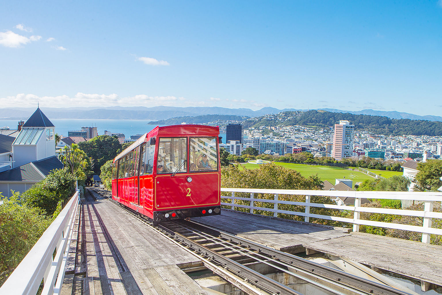 red wellington cable car riding up a hill in new zealand