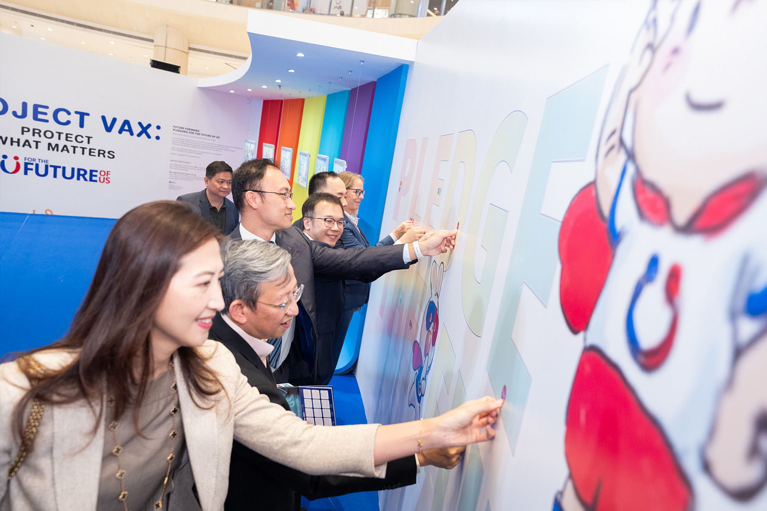Attendees pasting stickers and making a pledge during Pfizer's Project Vax: Protect What Matters event in March 2024