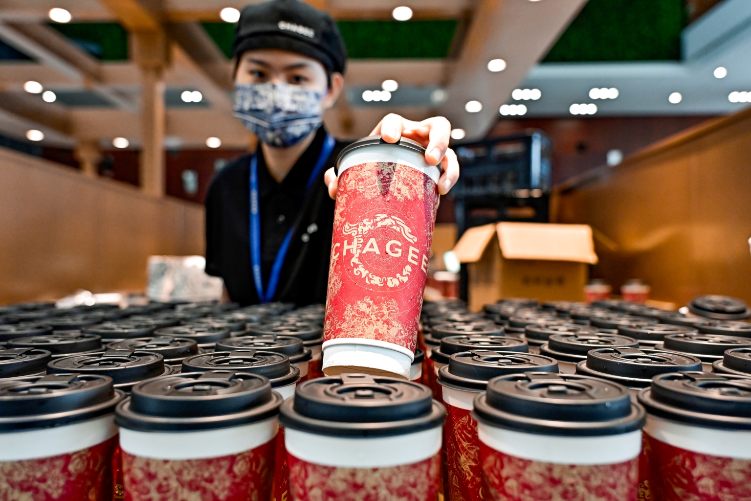 image of a chagee employee serving beverages