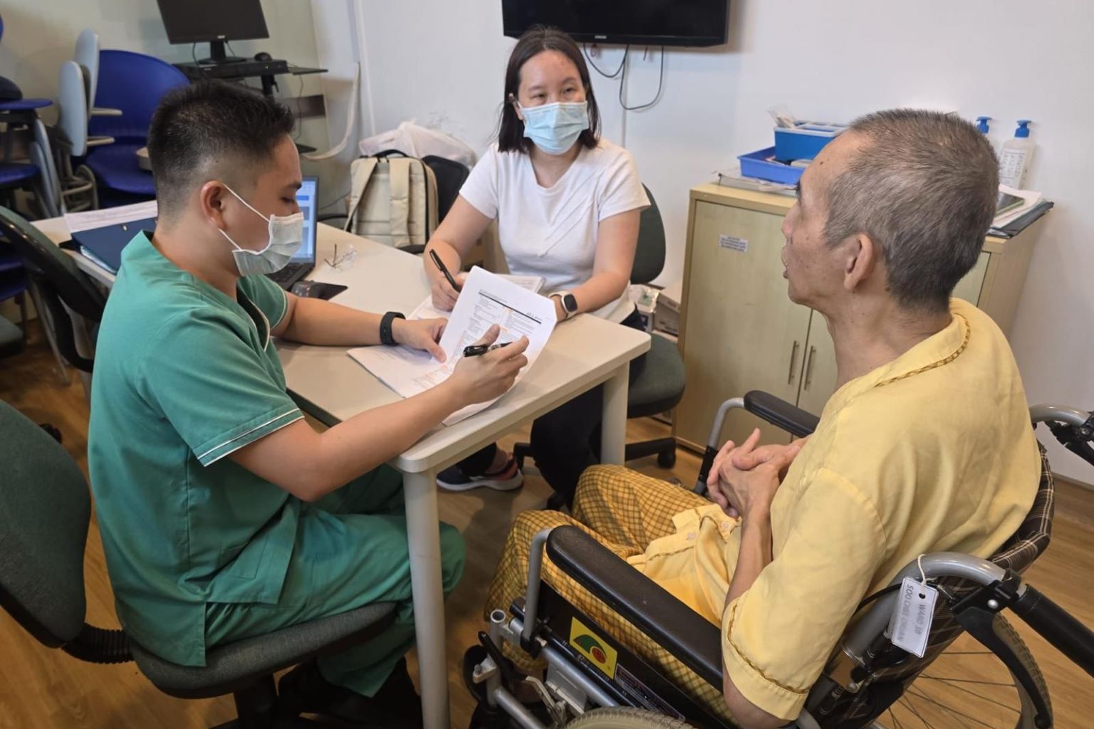 care staff conducting health screening for elderly in singapore